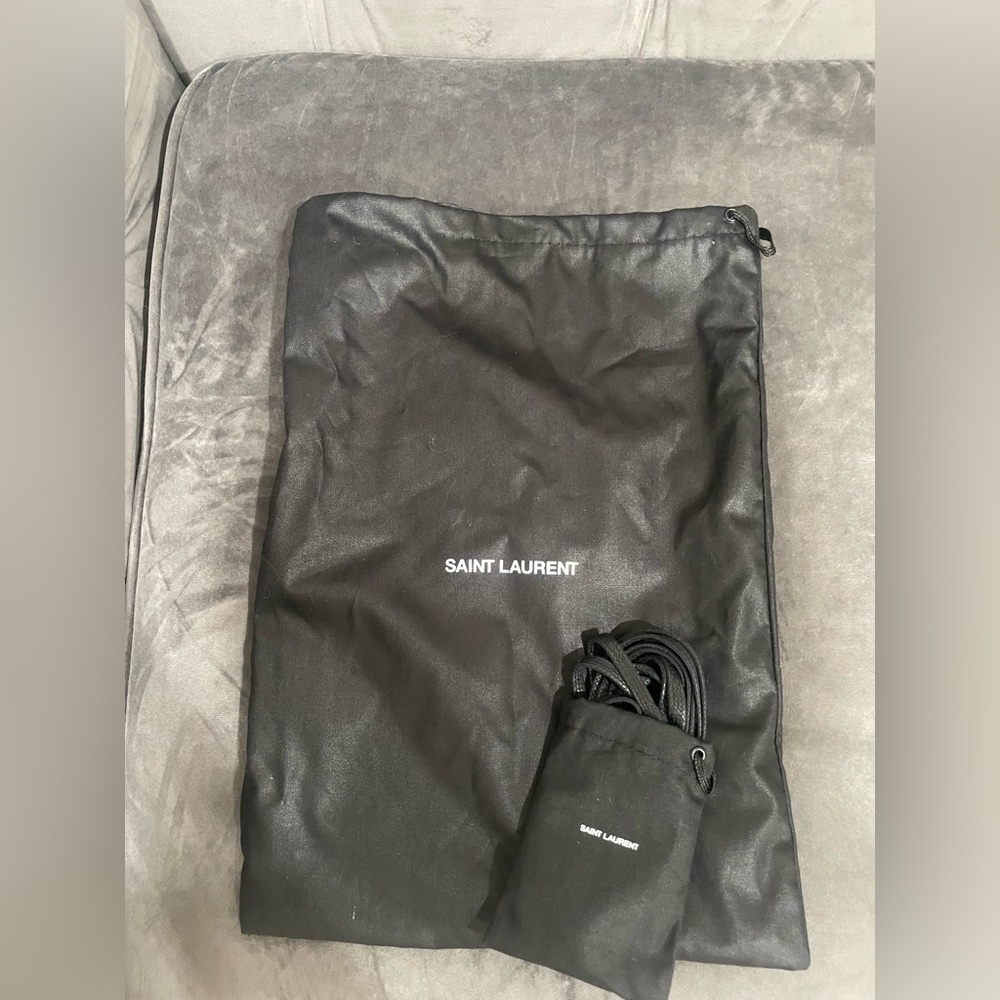 Black Saint Laurent dust bag with brand new set of black original laces.